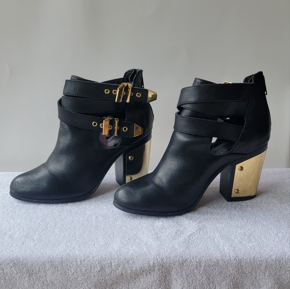 Black leather booties with gold hardware